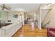 Spacious living room featuring hardwood floors seamlessly flowing into an adjacent kitchen area at 5435 Sweetwater Terrace Cir, Tampa, FL 33634