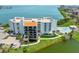 Stunning aerial view of the building with beautiful waterfront views and a refreshing pool at 5700 Escondida S Blvd # 401, St Petersburg, FL 33715