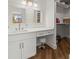 Bright bathroom featuring a vanity, makeup area, and large windows providing natural light at 5700 Escondida S Blvd # 401, St Petersburg, FL 33715