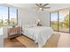 Comfortable bedroom with a ceiling fan, and sliding glass door access to the balcony at 5700 Escondida S Blvd # 401, St Petersburg, FL 33715
