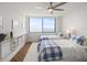 Inviting bedroom featuring two twin beds, ceiling fan, and scenic water view at 5700 Escondida S Blvd # 401, St Petersburg, FL 33715