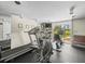 Well-equipped gym area with various exercise machines and natural lighting at 5700 Escondida S Blvd # 401, St Petersburg, FL 33715