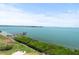Scenic waterfront view with a pier, lush greenery, and clear blue water at 5700 Escondida S Blvd # 401, St Petersburg, FL 33715