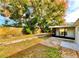 Spacious backyard featuring mature trees, a privacy fence, and an enclosed patio area perfect for outdoor entertaining at 5703 Andrea Dr, Holiday, FL 34690