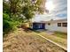 Expansive backyard featuring mature trees, a privacy fence, and a screened-in porch at 5703 Andrea Dr, Holiday, FL 34690
