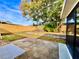A large backyard with a privacy fence, an enclosed patio, and mature trees to offer shade on sunny days at 5703 Andrea Dr, Holiday, FL 34690