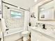 Bright bathroom with modern fixtures and marble-style tile at 5703 Andrea Dr, Holiday, FL 34690
