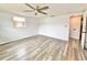 Spacious bedroom featuring a ceiling fan, and wood-look laminate flooring at 5703 Andrea Dr, Holiday, FL 34690