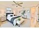 Stylishly decorated bedroom featuring a ceiling fan, hardwood floors, and neutral décor at 5703 Andrea Dr, Holiday, FL 34690