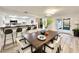 Open dining area with kitchen bar, modern lighting, and sliding doors to a screened patio at 5703 Andrea Dr, Holiday, FL 34690