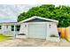 Exterior view of the home with an attached single-car garage and well-maintained landscaping at 5703 Andrea Dr, Holiday, FL 34690