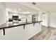 Updated kitchen with white cabinets, a dark countertop, stainless steel appliances, and modern lighting at 5703 Andrea Dr, Holiday, FL 34690