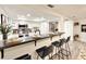 Kitchen featuring white cabinets, a dark countertop, stainless steel appliances, and modern lighting at 5703 Andrea Dr, Holiday, FL 34690