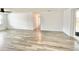 Bright, airy living room with light wood floors and a sliding glass door to the outdoor space at 5703 Andrea Dr, Holiday, FL 34690