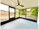 Relaxing sunroom with large windows and a view of the backyard at 5703 Andrea Dr, Holiday, FL 34690