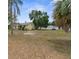 Sprawling backyard featuring a lush lawn and mature trees, ideal for outdoor activities at 6028 Central Ave, New Port Richey, FL 34653