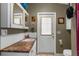 This quaint bathroom features a vanity with a unique counter, a bright door, and built-in storage at 6028 Central Ave, New Port Richey, FL 34653