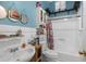 Well-lit bathroom features a shower-tub combo and a sink with storage at 6028 Central Ave, New Port Richey, FL 34653