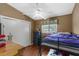Cozy bedroom with a ceiling fan, a twin bunk bed, a window, and closet at 6028 Central Ave, New Port Richey, FL 34653