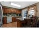 Warm and inviting kitchen with wood cabinets, granite countertops, and stainless steel appliances at 6028 Central Ave, New Port Richey, FL 34653
