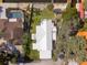 A beautiful overhead view of the home and adjacent property with a pristine white roof at 6726 Udell Ln, Hudson, FL 34667
