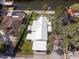 A beautiful overhead view of the home and adjacent property with a pristine white roof at 6726 Udell Ln, Hudson, FL 34667