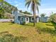 Backyard with a large palm tree and shed in the background at 6726 Udell Ln, Hudson, FL 34667