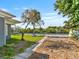 Backyard with a sidewalk, a tree, and grass at 6726 Udell Ln, Hudson, FL 34667