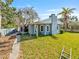 Backyard with a blue house and trees in the background at 6726 Udell Ln, Hudson, FL 34667