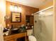 Rustic bathroom featuring a vessel sink, granite countertop, and a shower with glass doors at 6726 Udell Ln, Hudson, FL 34667