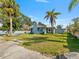 Charming single Gathering home featuring light blue siding and mature trees at 6726 Udell Ln, Hudson, FL 34667