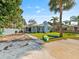 Charming single Gathering home with mature trees and lush lawn on a sunny day at 6726 Udell Ln, Hudson, FL 34667