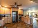 The kitchen with stainless steel refrigerator, custom cabinets and an open layout at 6726 Udell Ln, Hudson, FL 34667