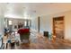 Spacious living room featuring a brick fireplace, wood floors, and neutral walls at 6726 Udell Ln, Hudson, FL 34667