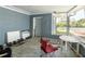 Enclosed porch with a table, chairs, and weights at 6726 Udell Ln, Hudson, FL 34667