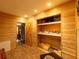 Wood-paneled room with built-in shelves and closet, showcasing ample storage and organization space at 6726 Udell Ln, Hudson, FL 34667