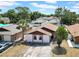 Aerial view of a home featuring a landscaped yard in a quiet residential neighborhood at 6915 N Hubert Ave, Tampa, FL 33614