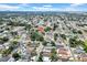 Sprawling aerial view of a well-planned neighborhood showcasing a mix of houses, trees, and neat streets at 6915 N Hubert Ave, Tampa, FL 33614
