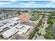 An aerial photograph shows a school and athletic fields in a vibrant community at 6915 N Hubert Ave, Tampa, FL 33614