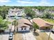 Aerial view of a single-Gathering home in a residential neighborhood with mature trees at 6915 N Hubert Ave, Tampa, FL 33614
