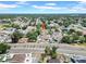 Expansive aerial view of a community with tree-lined streets and well-maintained homes on a sunny day at 6915 N Hubert Ave, Tampa, FL 33614