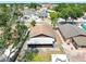 Home aerial view showcasing the backyard with a screened porch and storage at 6915 N Hubert Ave, Tampa, FL 33614