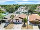 Aerial view showcasing a home within a lush, tree-lined residential community at 6915 N Hubert Ave, Tampa, FL 33614
