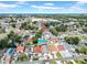 Aerial view of a vibrant community with houses, schools, and well-maintained roads under a clear sky at 6915 N Hubert Ave, Tampa, FL 33614