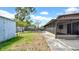 Large fenced backyard with a screen porch and storage shed at 6915 N Hubert Ave, Tampa, FL 33614