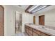 Well-lit bathroom featuring a double sink vanity and separate toilet and shower area at 6915 N Hubert Ave, Tampa, FL 33614