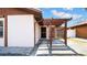 Welcoming front entrance with a pergola and lattice detail, providing shade and privacy at 6915 N Hubert Ave, Tampa, FL 33614