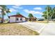 Cozy single-story home with a spacious driveway and simple landscaping at 6915 N Hubert Ave, Tampa, FL 33614