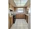 Charming kitchen boasts tile floor, wooden cabinets, and modern appliances at 6915 N Hubert Ave, Tampa, FL 33614