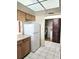 Bright kitchen features wood cabinets, tile floor, and appliances at 6915 N Hubert Ave, Tampa, FL 33614